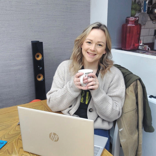 Photo of Kerry Ormerod owner and creator of Ivy Blossom Wax Melts and Home Fragrance, smiling holding a coffee cup